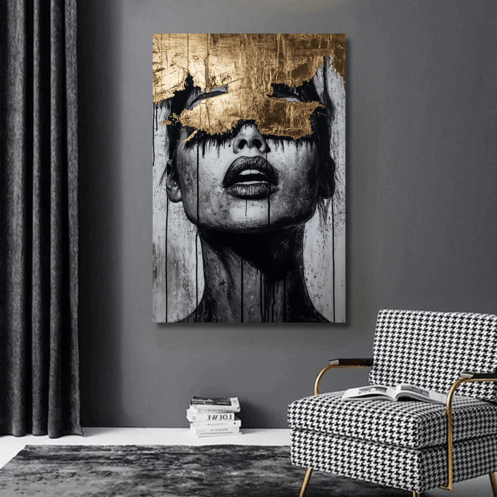 Abstract woman portrait wall art, black and white female face with gold leaf over the eyes hanging on a dark gray wall