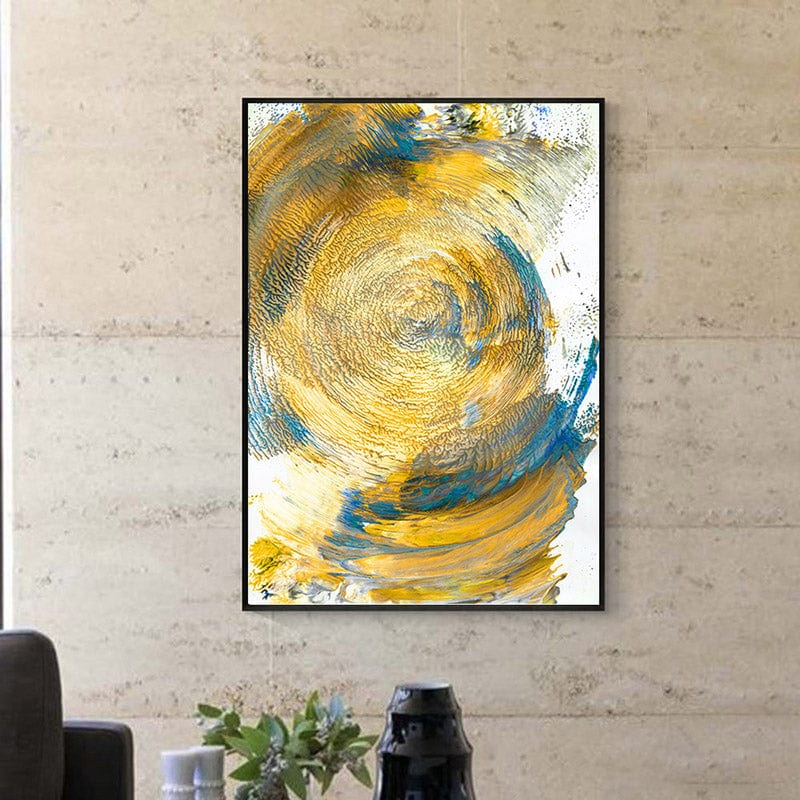 Abstract yellow and blue swirl wall art, circular brush strokes in a black frame against a stone wall