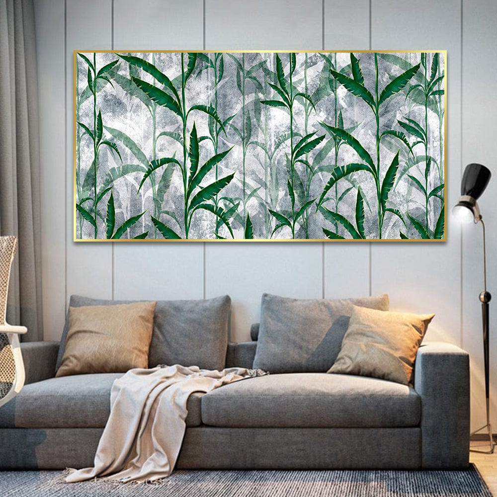 Green nature landscape wall art, tall bamboo stalks in gentle fog with delicate leaves in a gold frame above a sofa