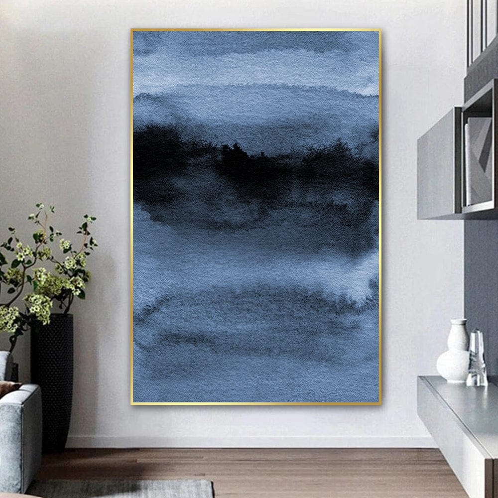 Abstract blue landscape wall art, dark blue and black watercolor wash painting in a thin gold frame hanging on a white wall