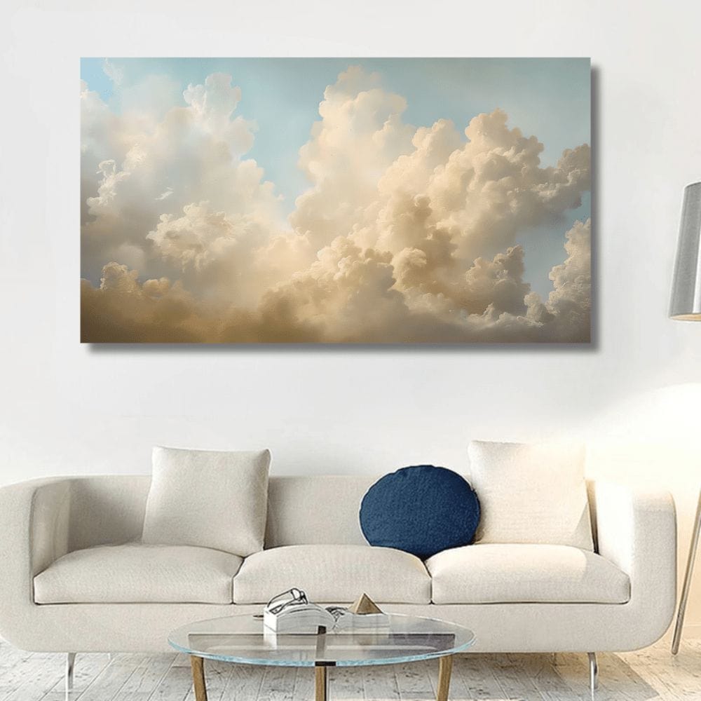 Blue sky landscape wall art, cream and gold billowing clouds above a white sofa in a living room