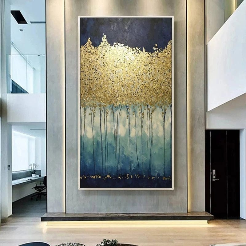 Abstract forest landscape wall art, gold leaf trees over a dark blue night sky hanging in a modern two story foyer