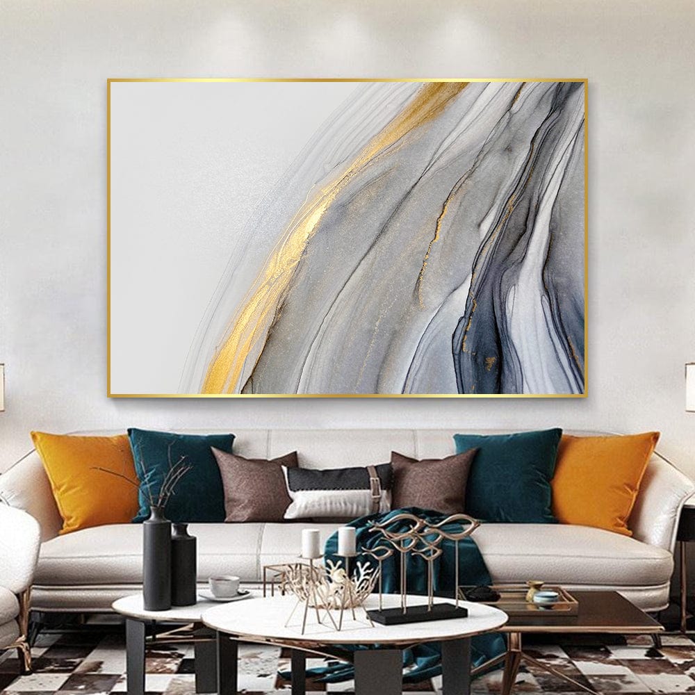 Abstract gold and grey landscape wall art, fluid marble paint swirls with metallic accents in a thin gold frame above a sofa
