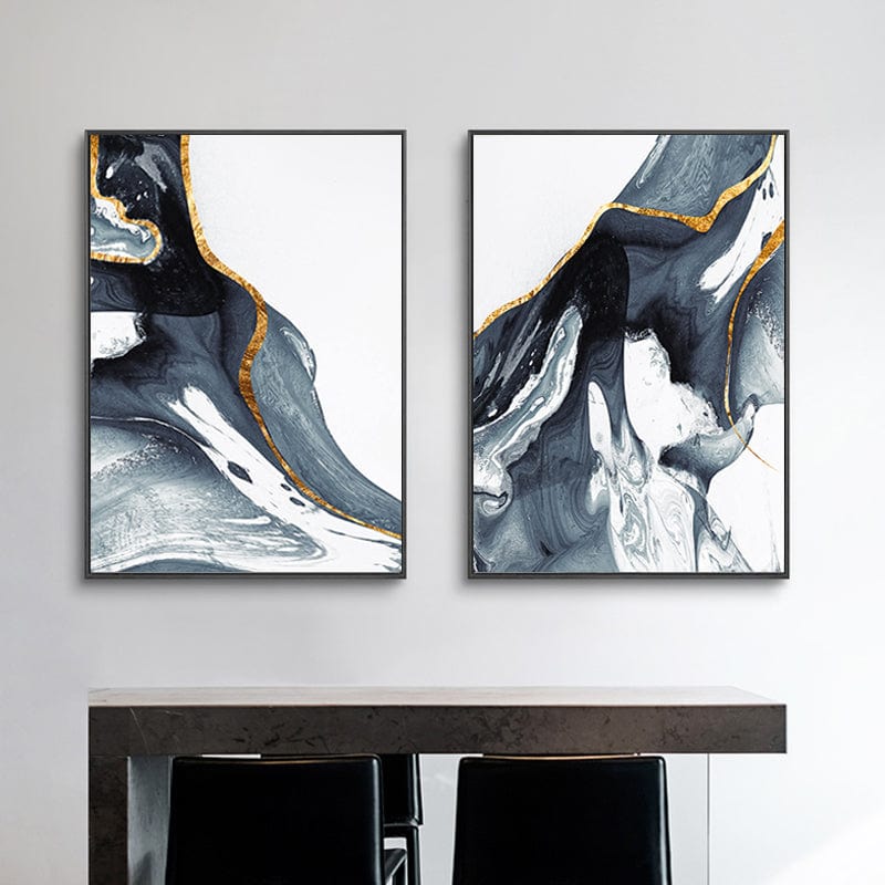 Abstract blue and gold fluid art wall art set in black frames above a console table