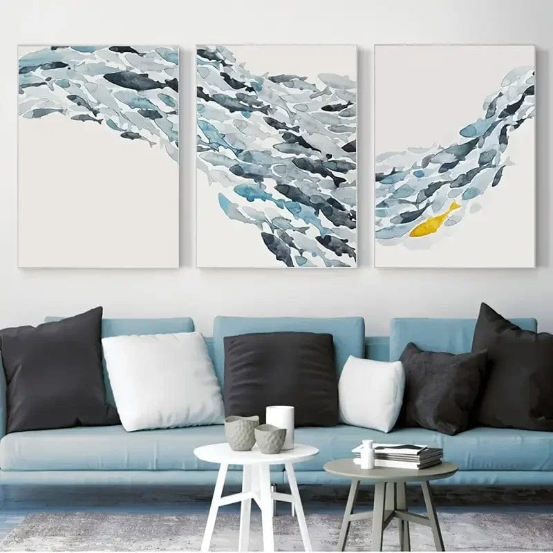 Calm Currents watercolor school of fish wall art, blue and grey ocean painting with a yellow fish hanging above a blue sofa
