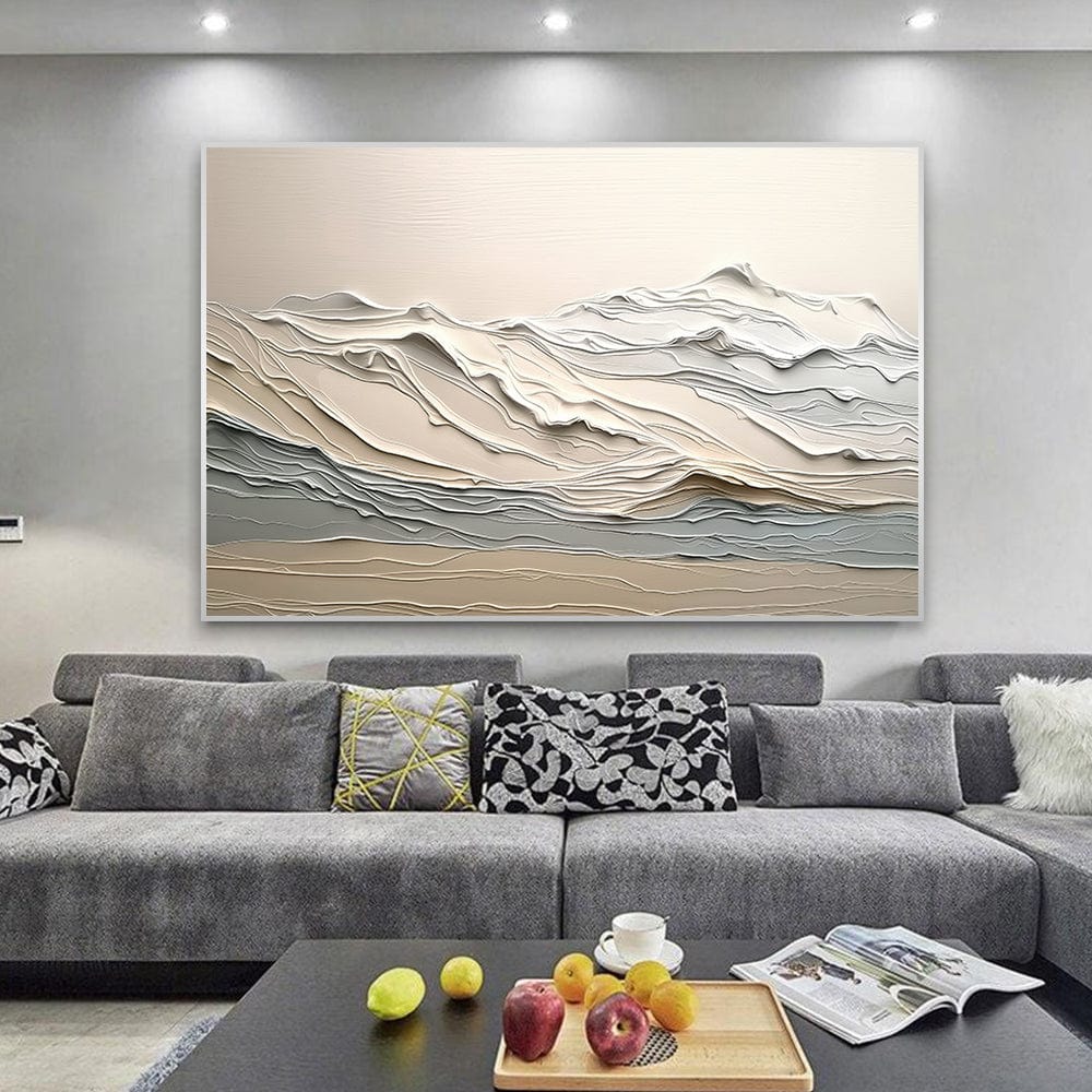 Neutral beige mountain landscape wall art, textured abstract nature painting in soft earth tones above a grey sofa