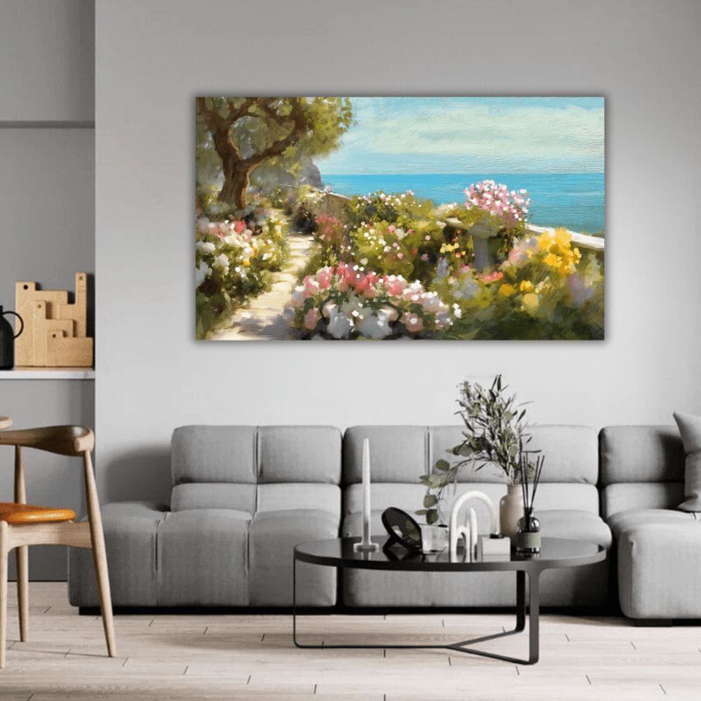 Coastal garden landscape wall art, blooming flowers along a seaside path overlooking the blue ocean above a gray sofa