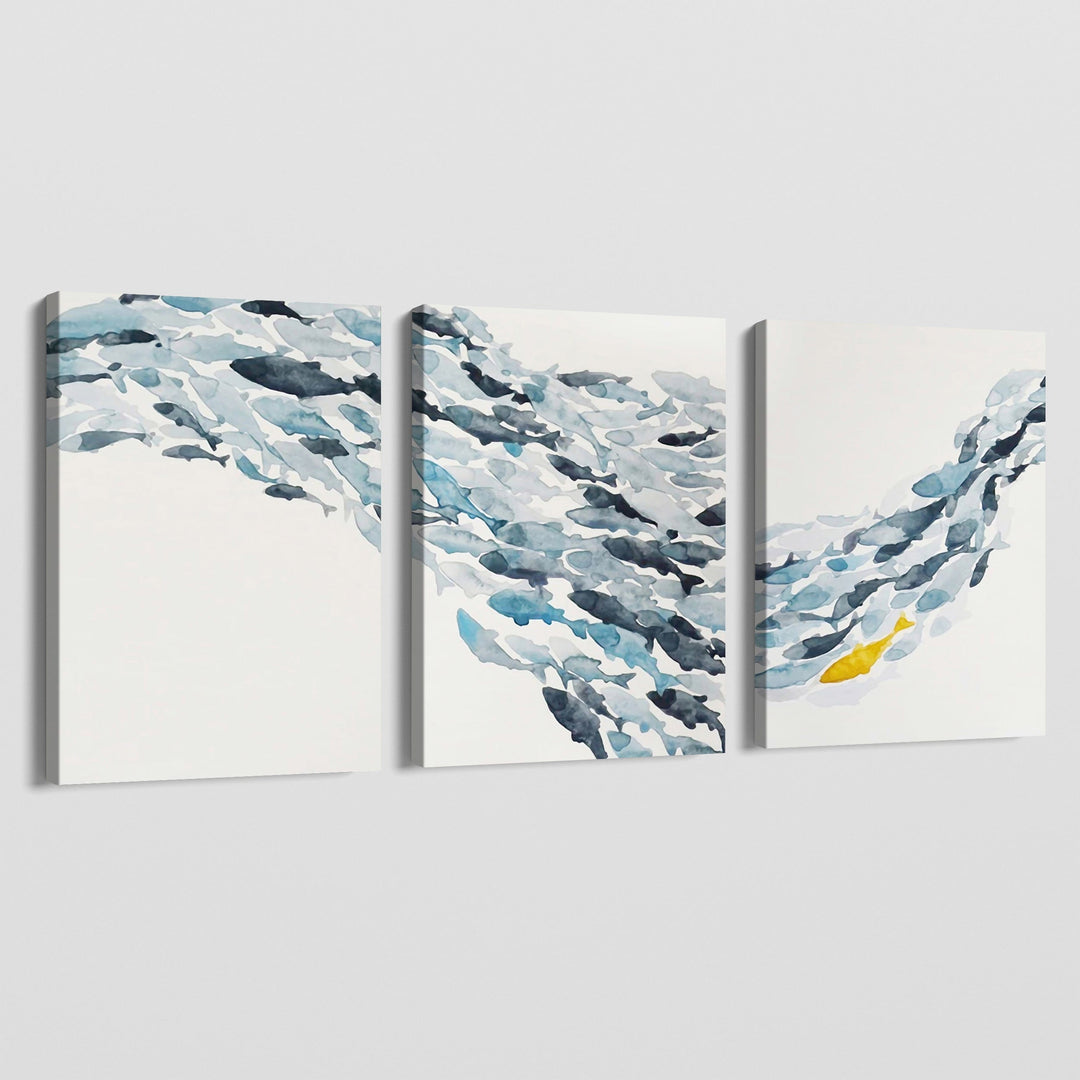 Calm Currents watercolor wall art, triptych of blue and grey fish swimming in an ocean current with a single yellow fish