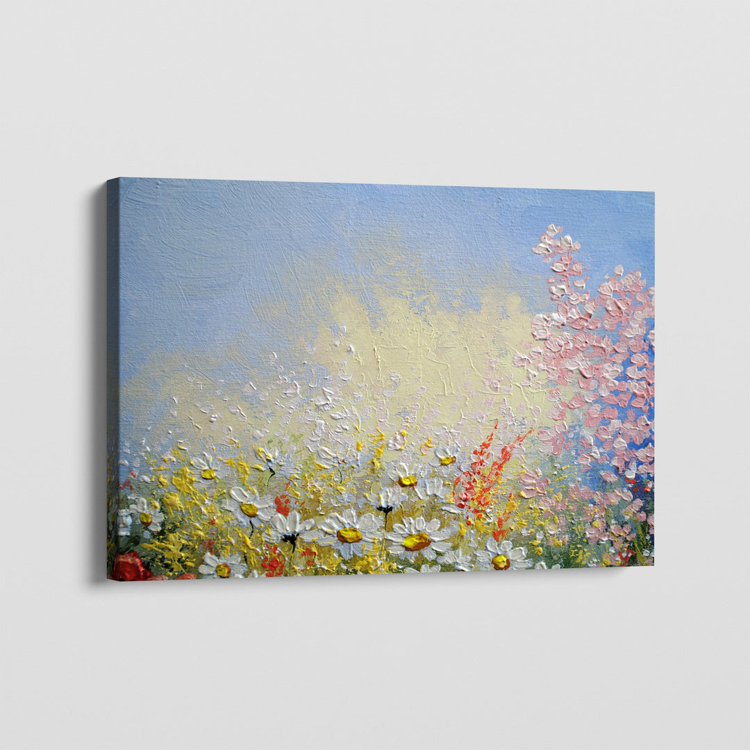 Abstract floral landscape wall art, textured field of white daisies and pink blossoms under a blue sky on stretched canvas