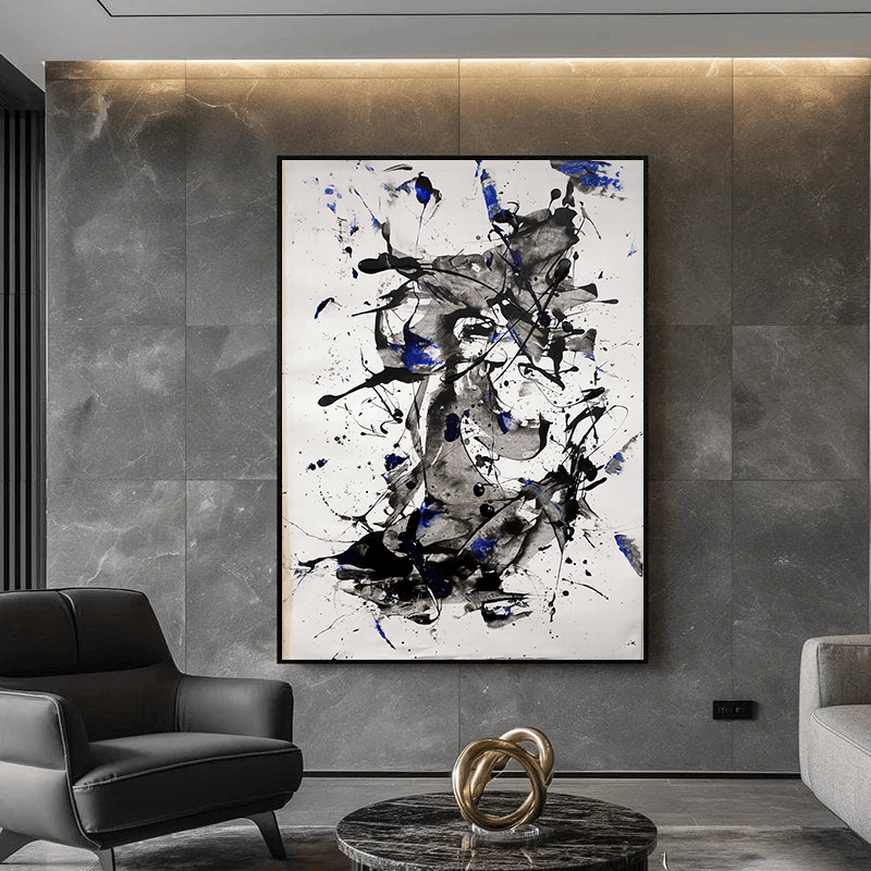 Abstract black and white painting wall art with cobalt blue splatters and charcoal brush strokes on a white background