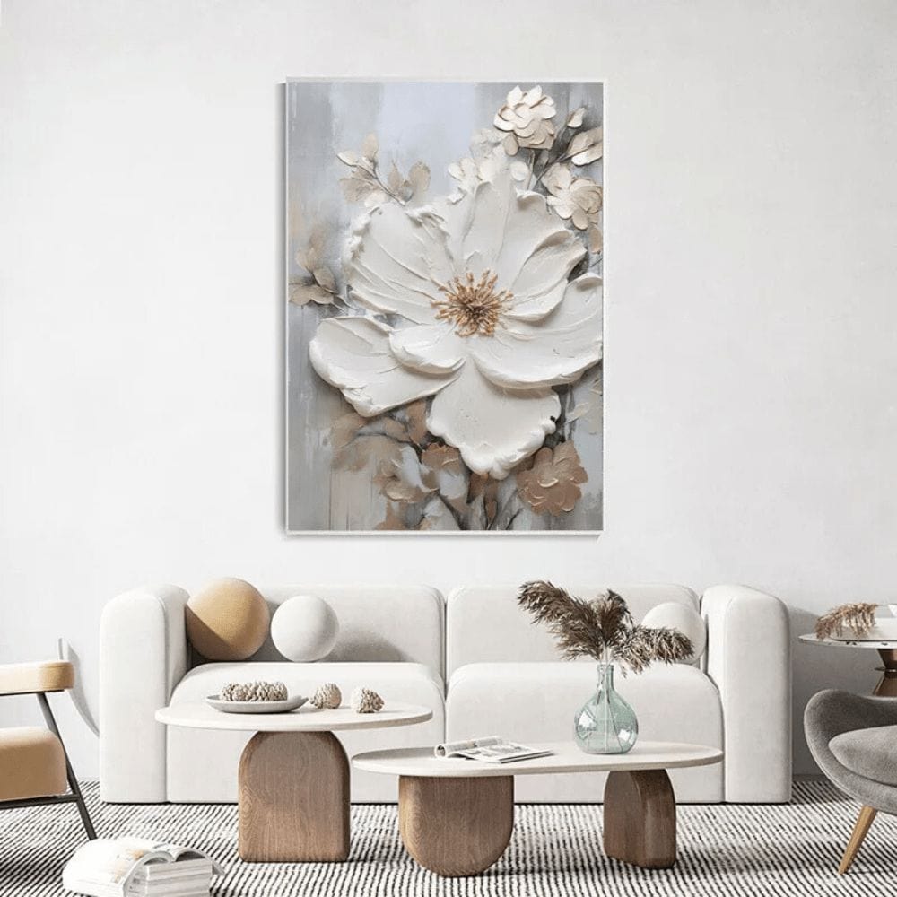 White and grey floral wall art, textured abstract flower painting with soft neutral hues above a sofa