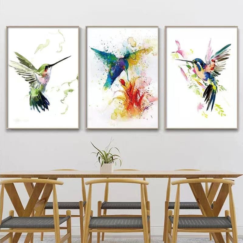 Vivid birds wall art, watercolor hummingbirds in flight over floral prints above a dining table