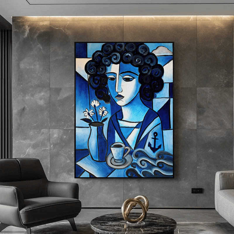 Blue woman portrait wall art, stylized female figure with curly hair, coffee cup, and anchor motif in a living room