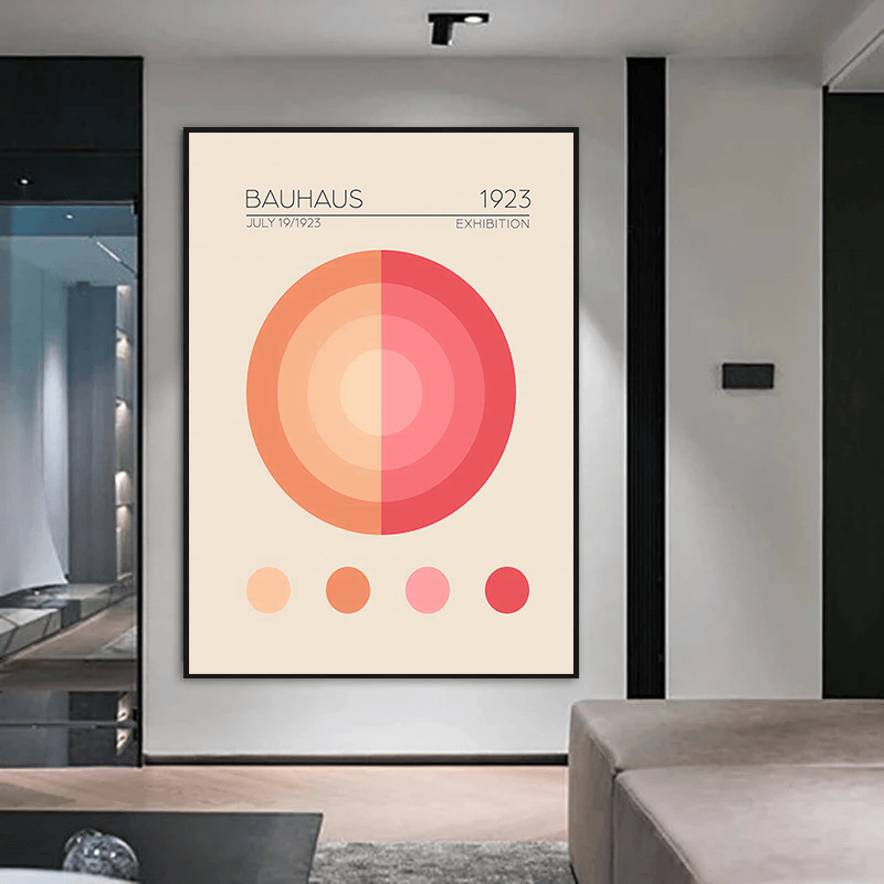 Geometric Bauhaus circles wall art in a black frame hanging in a hallway above a wooden bench