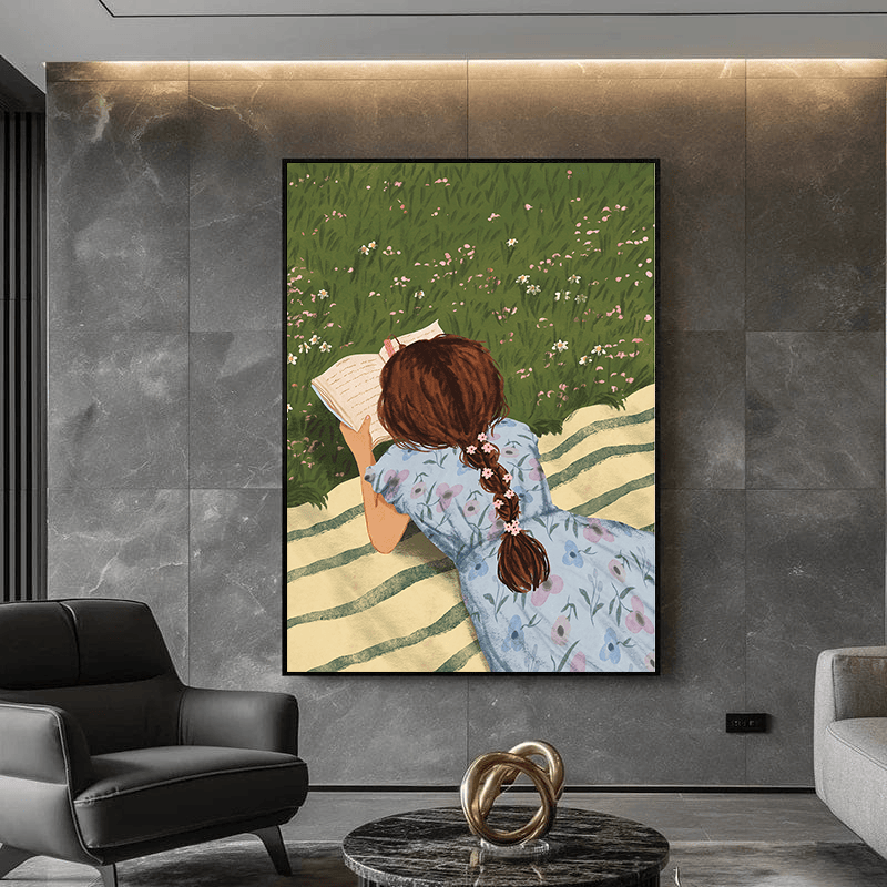 Bookworm wall art, woman reading a book lying in a flowering meadow on a striped blanket