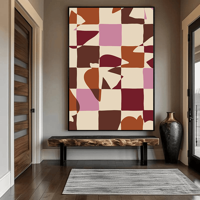 Coastal abstract geometric wall art with terracotta, pink and burgundy blocks hanging in an entryway above a bench