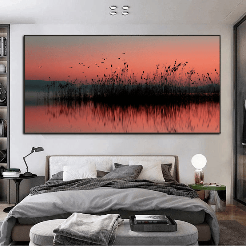 Serene waterside landscape wall art, dark reeds reflecting on calm water under a coral pink sunrise