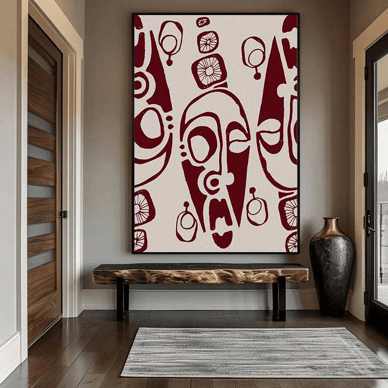 Ebonie portrait wall art, burgundy tribal faces and floral motifs on an ivory ground above a wooden bench