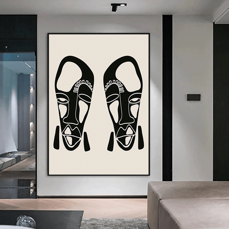 Abstract tribal faces wall art, bold black linework portrait on an ivory background in a black frame