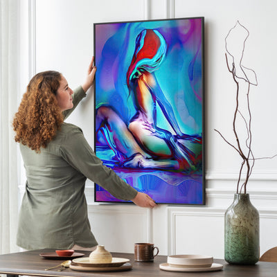 Woman hanging a colorful abstract painting on a wall