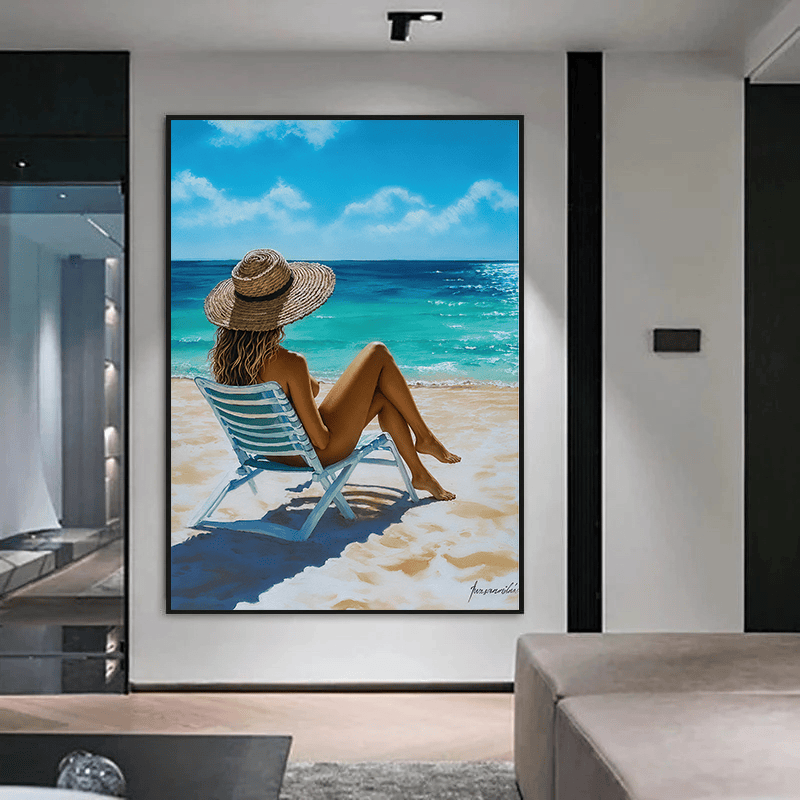 Beach woman painting wall art, woman in a straw sun hat on a beach chair by a turquoise sea, in a black frame