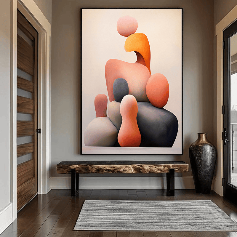 Modern abstract balance wall art, stacked sculptural forms in orange, grey, and cream against a pale background