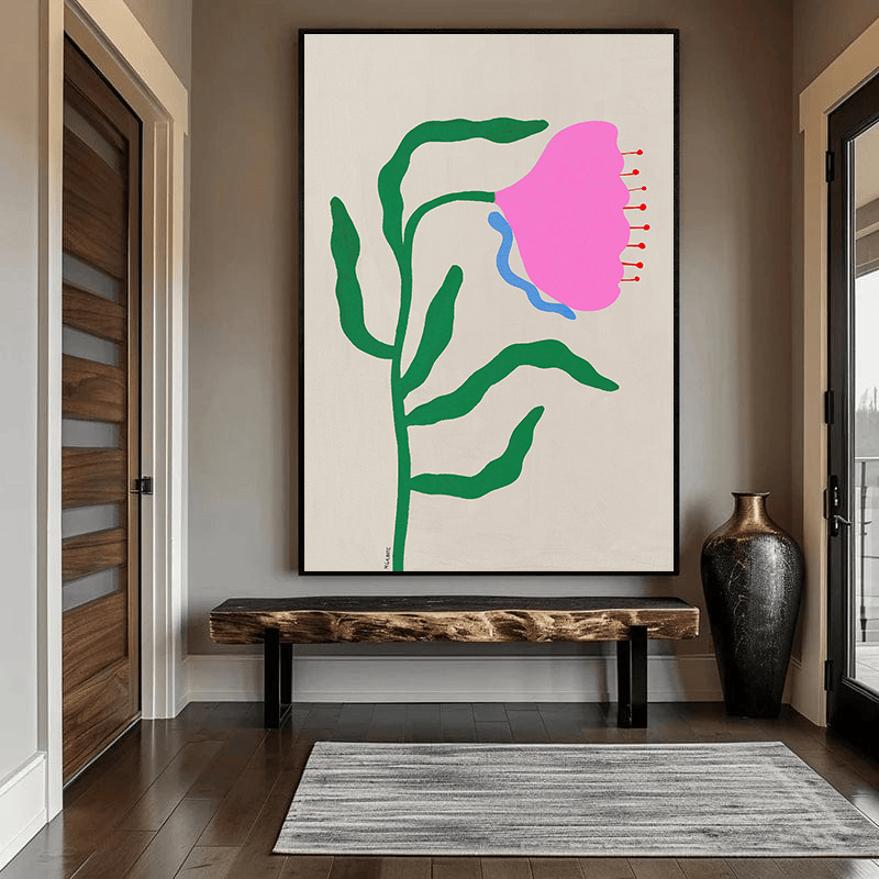 Pink abstract flower wall art, minimalist botanical painting with a pink bloom and green stem in a black frame in an entryway
