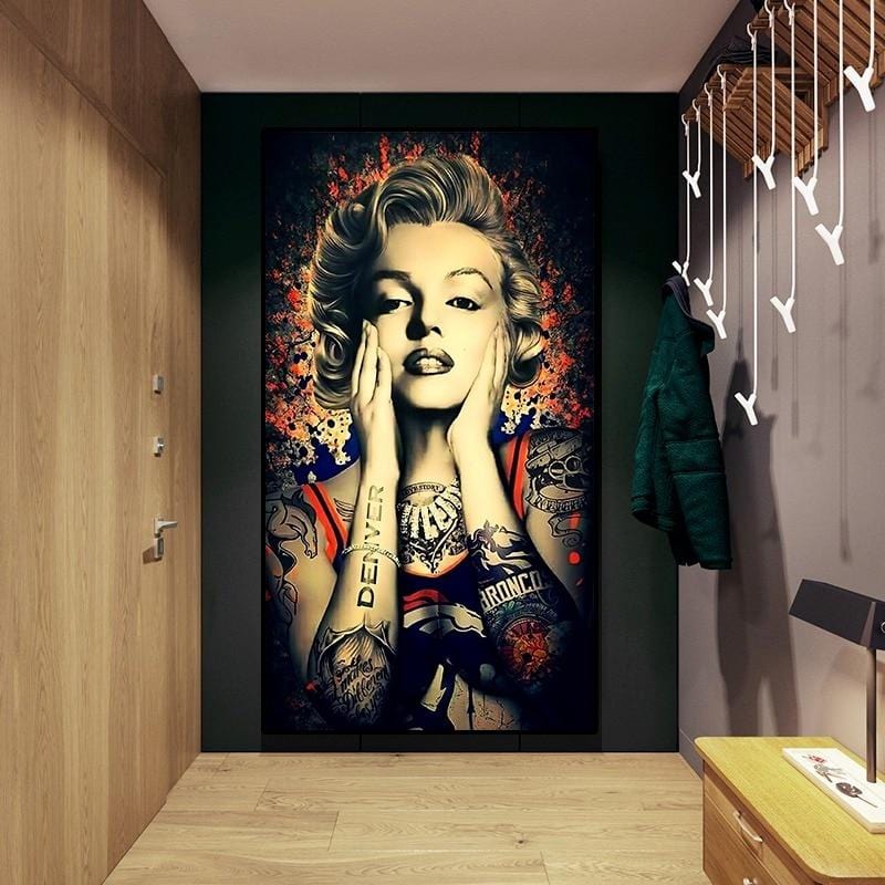 Tattooed woman portrait wall art featuring Marilyn Monroe hanging in a modern hallway with wooden walls and a lamp