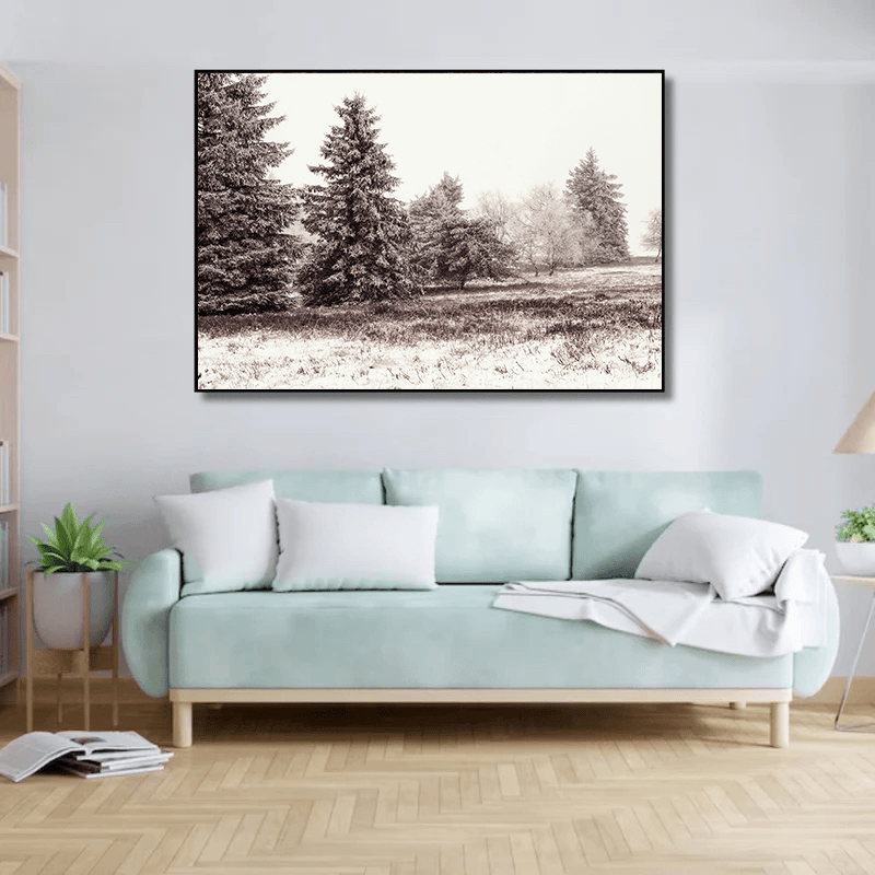 Snowy winter landscape wall art, sepia and ivory painting with tall evergreen trees above a mint green sofa