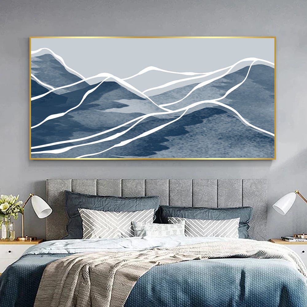 Blue abstract landscape wall art, indigo mountains with white contour lines in a gold frame above a bed