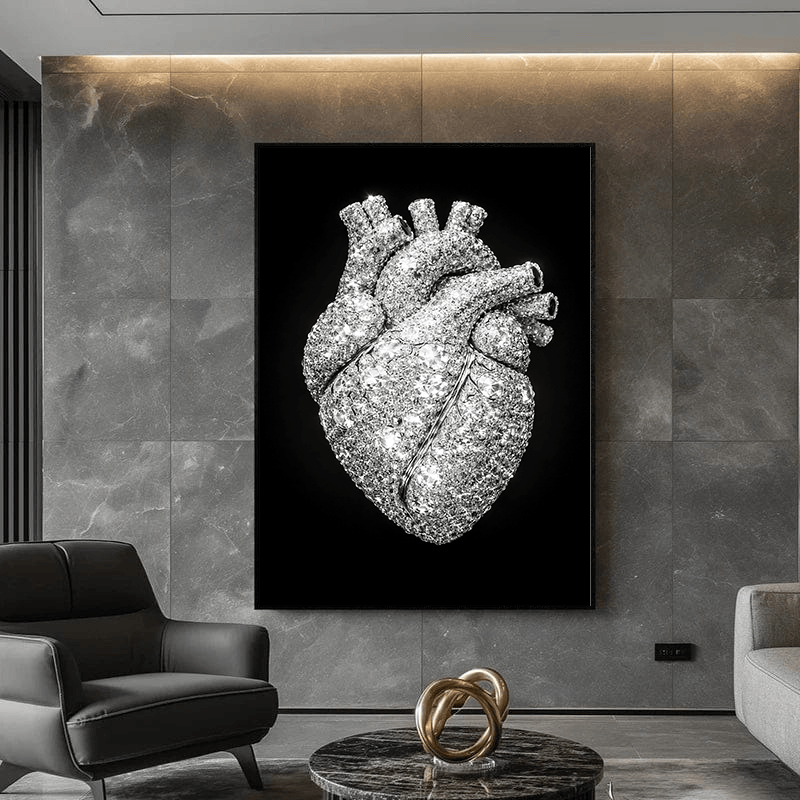 Black and white diamond heart portrait wall art in a black frame on a gray stone wall above an armchair in a living room