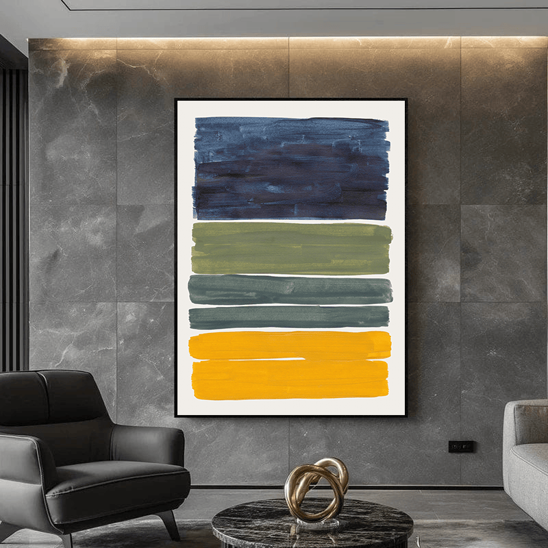 Stacked color blocks abstract painting wall art in a black frame hanging on a dark gray marble wall above a modern armchair