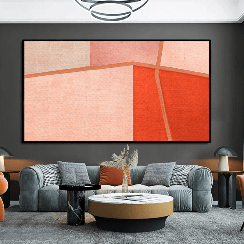 Abstract geometric architecture wall art, minimal composition in soft coral, blush, and warm orange tones over a sofa