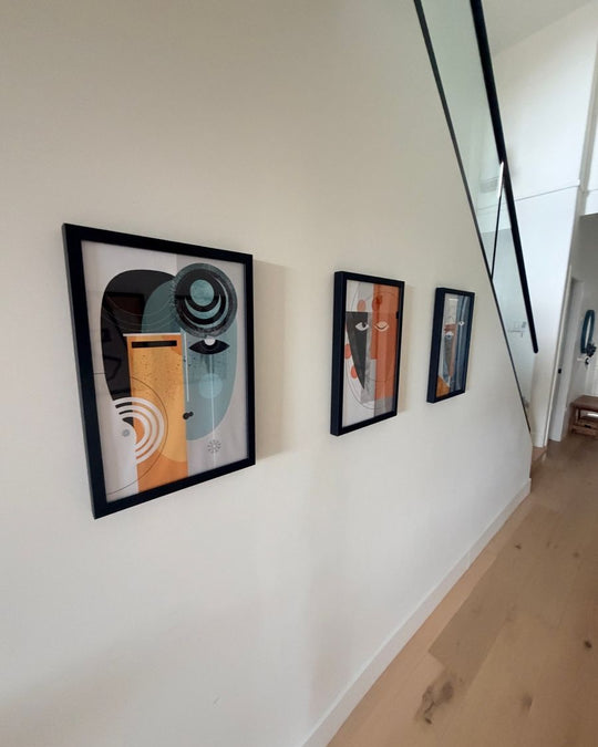 Three framed Abstract Geometric Women prints along a white hallway